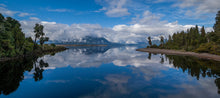 Load image into Gallery viewer, Still Lake Brunner reflecting the sky and surrounding mountains at Moana on the West Coast, New Zealand