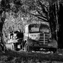 Load image into Gallery viewer, Old Bedford black and white photograph of a vintage Bedford truck beneath the trees in Tinwald, Canterbury, New Zealand