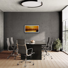 Load image into Gallery viewer, Grey River Sunset + Cranes fine art print displayed in a modern dark office interior