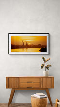 Load image into Gallery viewer, Grey River Sunset + Cranes fine art print displayed in a modern interior with black frame