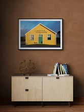 Load image into Gallery viewer, Donovan’s Store fine art photography print displayed framed in black above a cabinet 