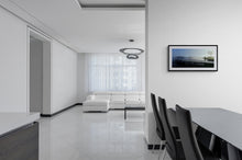 Load image into Gallery viewer, Lake Kaniere West Coast landscape photograph by Stewart Nimmo shown framed in a modern interior with a black frame