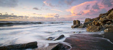 Load image into Gallery viewer, Waves around rocks at sunset at North Beach Cobden on the West Coast of New Zealand