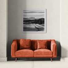 Load image into Gallery viewer, Framed Power Lines black and white fine art print displayed above an orange sofa