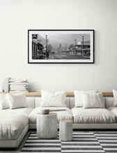 Load image into Gallery viewer, Framed Reefton black and white photography print by Stewart Nimmo displayed in a living room
