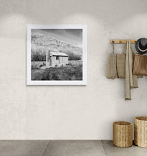Load image into Gallery viewer, Framed Old Tin Hut fine art print photographed by Stewart Nimmo displayed in a light neutral interior.