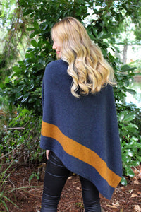 Asymmetrical possum merino poncho with geometric pattern in contrast colour. Textured knit structure feature in contrast panel. Lothlorian. Made in New Zealand.