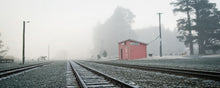 Load image into Gallery viewer, Misty Cass Railway Station in Canterbury, New Zealand, with railway tracks leading towards the small red station