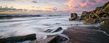 Load image into Gallery viewer, Waves around rocks at sunset at North Beach Cobden on the West Coast of New Zealand