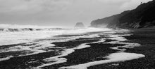 Load image into Gallery viewer, Black and white photograph of sea foam across Cobden Beach on the West Coast of New Zealand by Stewart Nimmo