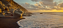 Load image into Gallery viewer, Warm evening light over rocks and waves at North Beach Cobden, West Coast New Zealand