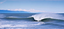 Load image into Gallery viewer, Breaking ocean wave off Blaketown, Greymouth with Aoraki Mount Cook and the Southern Alps on the horizon